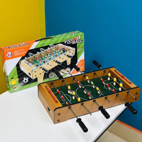 Wooden tabletop football game for kids with mini players and handles, perfect for indoor fun and family play.
